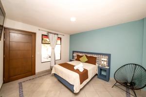 a bedroom with a bed and a door and a television at El Jazmin de Zanya in Dolores Hidalgo