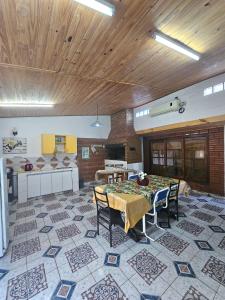 a large room with a table and chairs on a tile floor at La joyita in Ituzaingó