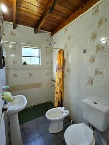 a bathroom with a toilet and a sink at La joyita in Ituzaingó