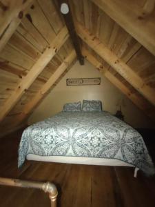 a bedroom with a bed in a attic at Tranquil Waters Cabin in Frenchburg