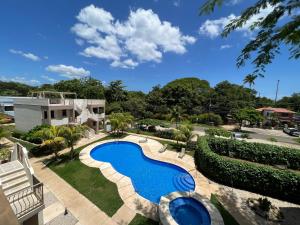an image of a swimming pool at a resort at Charming condo with a rooftop, across beach in Coco