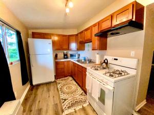 a kitchen with a stove and a white refrigerator at Downtown Hobart Cozy 1 Bedroom in Hobart