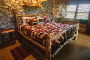 a bed in a room with a stone wall at Dolly Bear Mountain View in Sevierville