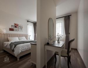 Postel nebo postele na pokoji v ubytování Davilla Đà Lạt Villa Collection