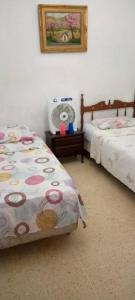 a bedroom with two twin beds and a fan at Candida in Caracas