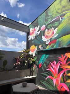a mural of flowers on the side of a building at Hotel Cocli in Roldanillo