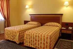 Postel nebo postele na pokoji v ubytování Hotel Grillo