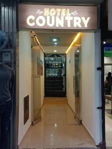 a hotel entrance with a sign on the door at Hotel Country Medellin in Medellín