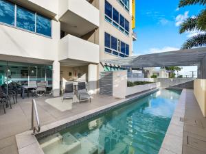 an exterior view of a house with a swimming pool at Nova Mooloolaba Beach Apartments in Mooloolaba