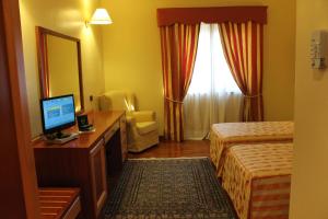 Postel nebo postele na pokoji v ubytování Hotel Grillo