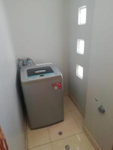 a small refrigerator sitting in a corner of a room at Apart Hotel Costa Verde in Tacna