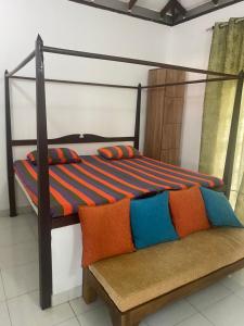 a bedroom with a bunk bed and a bench at Savenndra Resorts in Malwana