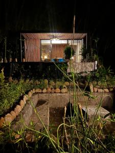 a house with a pond in a garden at night at Glamping Salento con jacuzzi climatizado in Salento