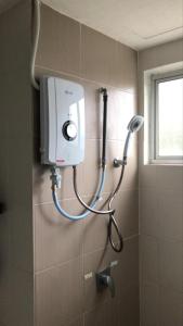 a shower in a bathroom with a shower at Cameron Highlands Homestay in Tanah Rata