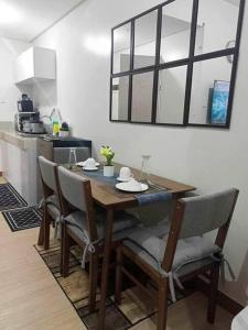 a dining room table and chairs in a kitchen at Chelsea Suite's Esthetic Staycation at Trees Residence QC in Manila