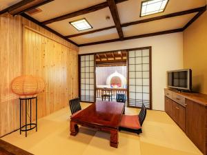 a living room with a table and a tv at Tsuruya / Vacation STAY 59071 in Miyaji