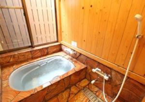 a bathroom with a bath tub in a room at Tsuruya / Vacation STAY 59071 in Miyaji +73 photos