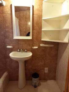 a bathroom with a sink and a mirror at MAE in Esquel