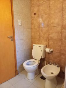 a bathroom with a toilet and a bidet at MAE in Esquel