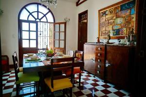 a kitchen with a table and chairs and a window at Casa Blanca María Barranquilla - Authentic colonial house in Barranquilla