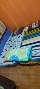 a bed with pillows on the floor in a room at Home Sweet Home in Kuching