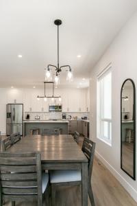 a dining room and kitchen with a table and chairs at Luxurious Home in Lake Cowichan in Lake Cowichan