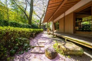 a walkway next to a building with a bench at Oukai Villa Izumi in Izumi