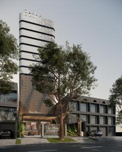 an office building with a tree in front of it at The Alana Hotel Malang in Malang
