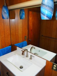 a bathroom with a sink and a mirror at Cavalier Cottage - Private Lakefront w Kayaks! in Honor +38 photos