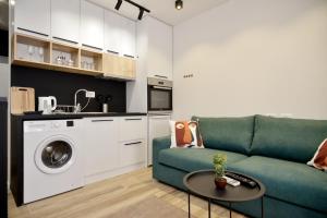 a living room with a couch and a washing machine at Tirana Central Apartments in Tirana