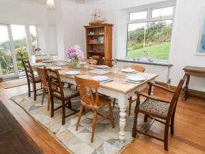 a dining room with a table and chairs at Penmarth House in Helston