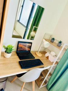 a laptop computer sitting on top of a wooden desk at Simple but cozy 1BR Shore 2 MOA in Manila
