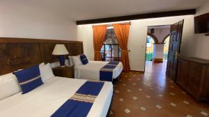 Postel nebo postele na pokoji v ubytování Hotel Hacienda Monteverde San Miguel de Allende