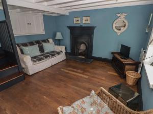 a living room with a couch and a fireplace at Patty's Cottage in Haverfordwest