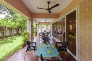 a patio with a table and chairs on a house at Serene Villa by StayVista - A Hill-View Villa with Plunge pool in Karjat