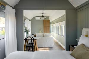 a room with two beds and a table and a couch at The Station Hunter Valley in Pokolbin
