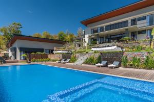 a swimming pool in front of a house at Villa Lovina Hill Paradise in Buleleng