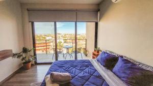 a bedroom with a bed and a balcony with a view at NEW Terra Condo w/ Infinity Pool in Cabo San Lucas +56 photos