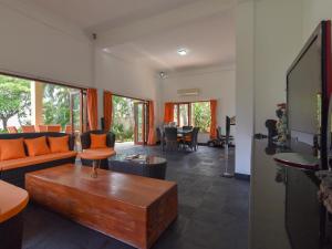 a living room with a couch and a table at Villa Singkenken in Kubutambahan