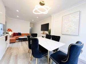 a living room with a white table and chairs at Churchill’s Rest in Sydney