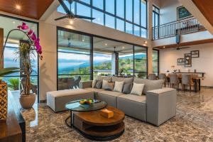 a living room with a couch and a table at Villa Lovina Hill Paradise in Buleleng