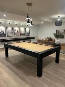 a ping pong table in a living room at Blooming Journey in Tampa Bay! in Tampa