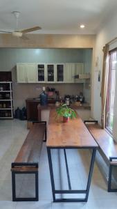 a kitchen with a large wooden table with two benches at Gorga hostel in Timuran