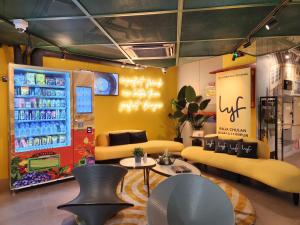 a store with a soda machine and tables and chairs at lyf Chinatown Kuala Lumpur in Kuala Lumpur