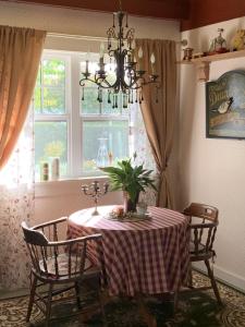 a dining room with a table and chairs and a window at The Hazelhouse in Chilliwack