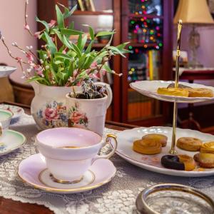 a table with a cup of tea and plates of pastries at The Hazelhouse in Chilliwack