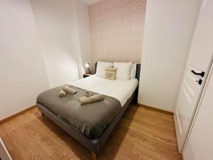 a bedroom with a bed with two towels on it at 2 - Hypercentre - FREE Parking - clim - wifi - netflix in Libourne