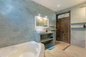 a large bathroom with a tub and a sink at Villa Bumi - Playful & Quirky 3BR Villa Near Seminyak, a Unique Getaway in Kerobokan +31 photos