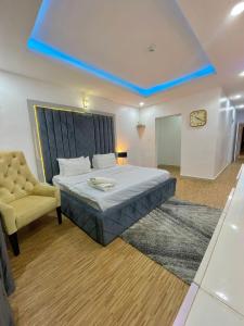 een slaapkamer met een bed en een gele stoel bij WATER VIEW 3 BEDROOM APARTMENT WITH JACUZZI PARKING WiFi NETFLIX POOL in Lekki