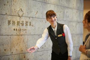 a young man in a vest talks to another woman at Tateshina Shinyu Onsen in Chino +189 photos